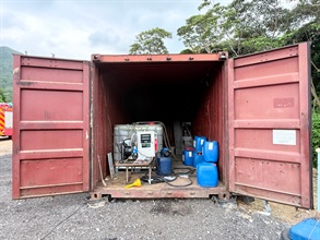 Hong Kong Customs and the Fire Services Department mounted a territory-wide operation targeting illicit fuel activities on June 10. During the operation, officers of the two departments detected two related cases and seized about 3 200 litres of illicit motor spirit, with an estimated market value of about $104,000 and a duty potential of about $20,000. Two persons were arrested, and one vehicle connected with one of the cases was also seized. Two persons were arrested, and one vehicle connected with one of the cases was also seized. Photo shows an illegal fuelling station raided in Tung Chung.
