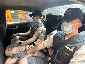 Hong Kong Customs seized about 81.2 kilograms of suspected cannabis buds with an estimated market value of about $14.5 million at Hong Kong International Airport on June 14. Photo shows a local man (centre), who was suspected to be connected with the case.