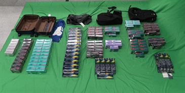 An incoming Chinese man was sentenced to six months' imprisonment and fined $1,000 by the West Kowloon Magistrates' Courts today (June 17) for importing duty-not-paid cigarettes, failing to declare them to Customs officers, as well as importing alternative smoking products, in contravention of the Dutiable Commodities Ordinance and the Import and Export Ordinance. Photo shows the duty-not-paid cigarettes and alternative smoking products seized.