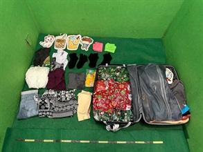 Hong Kong Customs today (June 22) detected a drug trafficking case involving baggage concealment at Hong Kong International Airport and seized about 12 kilograms of suspected cannabis buds with an estimated market value of about $2.1 million. Photo shows the suspected cannabis buds, which were wrapped by paper and concealed inside the suitcase.