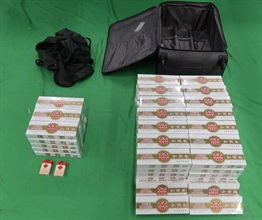 Two incoming male passengers were sentenced to four weeks’ imprisonment with a fine of $1,000, and three months' imprisonment with a fine of $1,000, respectively by the Courts today (June 22) for possessing or importing duty-not-paid cigarettes and failing to declare them to Customs officers, in contravention of the Dutiable Commodities Ordinance. Photo shows the duty-not-paid cigarettes seized from the personal baggage of an incoming 44-year-old Chinese male passenger.