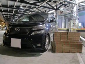 A 58-year-old incoming Chinese male driver was convicted at the West Kowloon Magistrates' Courts today (June 22) for importing duty-not-paid cigarettes and making use of an altered structure of a vehicle for the purpose of smuggling articles, in contravention of the Dutiable Commodities Ordinance and the Import and Export Ordinance. He was sentenced to four months' imprisonment for each of the charges that will run concurrently. Photo shows the duty-not-paid cigarettes seized and the vehicle concerned.