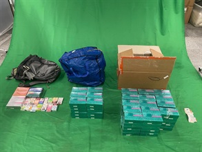 Two incoming Chinese male passengers were sentenced to between eight to ten weeks' imprisonment and fined $500 by the West Kowloon Magistrates' Courts today (June 27) for importing duty-not-paid cigarettes and failing to declare them to Customs officers, as well as for importing alternative smoking products (ASPs), in contravention of the Dutiable Commodities Ordinance and the Import and Export Ordinance. Photo shows the duty-not-paid cigarettes and ASPs seized.