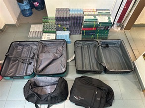 Two incoming air passengers were each sentenced to five months' imprisonment by the West Kowloon Magistrates' Courts on July 4 for importing and dealing with duty-not-paid cigarettes, in contravention of the Dutiable Commodities Ordinance (Cap. 109). One of them was also fined $1,000. Photo shows the illicit cigarettes seized from the personal baggage of one of the incoming air passengers.