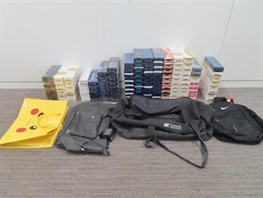 Two incoming air passengers were sentenced to five months' imprisonment by the Kowloon City Magistrates' Courts on July 4 for importing and dealing with duty-not-paid cigarettes, in contravention of the Dutiable Commodities Ordinance (Cap. 109). One of them was also fined $1,000. Photo shows the illicit cigarettes seized from the personal baggage of one of the incoming passengers.