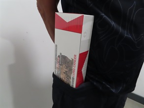 A local man was sentenced to four weeks’ imprisonment by the Fanling Magistrates' Courts today (July 8) for possessing duty-not-paid cigarettes, in contravention of the Dutiable Commodities Ordinance. Photo shows the duty-not-paid cigarettes around the waist of a 60-year-old man.