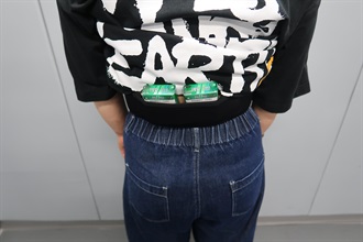 An incoming female passenger was sentenced to four weeks' imprisonment with a fine of $1,000 by the Fanling Magistrates' Courts today (July 9) for possessing duty-not-paid cigarettes and failing to declare them to Customs officers, in contravention of the Dutiable Commodities Ordinance. Photo shows duty-not-paid cigarettes concealed around the waist of a 54-year-old incoming local female passenger that were covered by a T-shirt.
