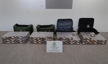 Two incoming air passengers were each sentenced to eight months' imprisonment by the West Kowloon Magistrates' Courts today (July 10) for dealing with duty-not-paid cigarettes, in contravention of the Dutiable Commodities Ordinance (Cap. 109). Photo shows the illicit cigarettes seized from the personal baggage of one of the incoming passengers.