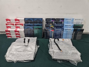 Two incoming passengers were sentenced to seven months' imprisonment with a fine of $1,000 by the Kowloon City Magistrates' Courts on July 18 for importing duty-not-paid cigarettes, in contravention of the Dutiable Commodities Ordinance (Cap. 109). Photo shows the illicit cigarettes seized from the personal baggage of the 38-year-old Mainland female passenger.