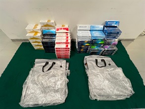 Two incoming passengers were sentenced to seven months' imprisonment with a fine of $1,000 by the Kowloon City Magistrates' Courts on July 18 for importing duty-not-paid cigarettes, in contravention of the Dutiable Commodities Ordinance (Cap. 109). Photo shows the illicit cigarettes seized from the personal baggage of the 32-year-old Mainland male passenger.