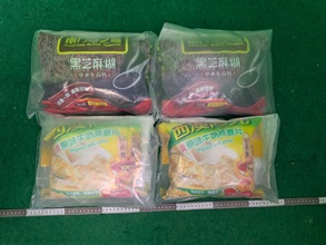 Hong Kong Customs yesterday (July 21) and today (July 22) detected three drug trafficking cases involving incoming air passengers at Hong Kong International Airport and seized a total of about 5.4 kilograms of suspected cocaine and about 14kg of suspected methamphetamine, with a total estimated market value of about $11 million. Three men were arrested. Photo shows the suspected methamphetamine concealed in beverage packages in the second case.