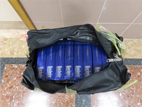 Two incoming air passengers were each sentenced to 10 months' imprisonment by the West Kowloon Magistrates' Courts today (August 12) for dealing with duty-not-paid cigarettes, in contravention of the Dutiable Commodities Ordinance (Cap. 109). Photo shows some duty-not-paid cigarettes seized from the personal baggage of one of the incoming passengers.