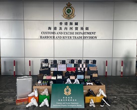 Hong Kong Customs from August 12 to 14 seized a total of about 25 000 suspected counterfeit goods and 1 000 suspected illicit cigarettes with a total estimated market value of about $8.5 million at the Tuen Mun River Trade Terminal. Photo shows some of the suspected counterfeit goods and suspected illicit cigarettes seized.