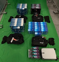 兩名入境男旅客因進口未完稅香煙及未有向海關人員作出申報，違反《應課稅品條例》，今日（八月二十四日）在西九龍裁判法院各被判處監禁十一個月和罰款二千元。圖示於三十七歲抵港內地男旅客的個人行李內檢獲的未完稅香煙。
