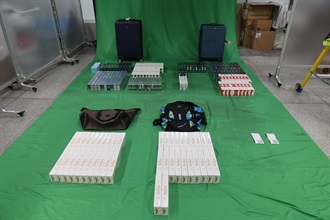 Two incoming male passengers were each sentenced to six months' imprisonment with a fine of $2,000 by the West Kowloon Magistrates' Courts today (September 7) for importing duty-not-paid cigarettes and failing to declare them to Customs officers, in contravention of the Dutiable Commodities Ordinance. Photo shows the duty-not-paid cigarettes seized from the personal baggage of the 32-year-old incoming Mainland male passenger.