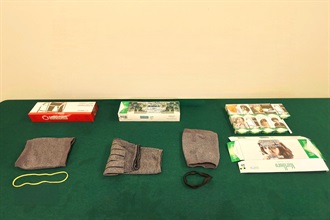 An incoming local female was sentenced to six weeks' imprisonment with a fine of $1,000 by the Fanling Magistrates' Courts today (September 9) for possessing duty-not-paid cigarettes and failing to declare them to Customs officers, in contravention of the Dutiable Commodities Ordinance. Photo shows the duty-not-paid cigarettes seized and the clothing used to conceal the duty-not-paid cigarettes.