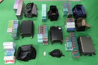 Three incoming passengers were sentenced to six to seven months’ imprisonment and fined $800 to $1,000, by the West Kowloon Magistrates' Courts yesterday (September 10) and today (September 11) for importing and dealing with duty-not-paid cigarettes, failing to declare them to Customs officers, as well as importing alternative smoking products, in contravention of the Dutiable Commodities Ordinance and the Import and Export Ordinance. Photo shows the duty-not-paid cigarettes and alternative smoking products seized from the personal baggage of a 49-year-old incoming Mainland female passenger and a 30-year-old incoming Mainland male passenger.