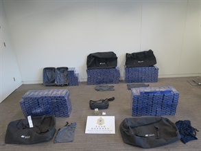 Four incoming air passengers were sentenced to eight to nine months imprisonment, each with a fine of $2,000, by the West Kowloon Magistrates' Courts yesterday (September 16) and today (September 17) for importing duty-not-paid cigarettes and failing to declare them to Customs, in contravention of the Dutiable Commodities Ordinance (Cap. 109). Photo shows duty-not-paid cigarettes seized from the personal baggage of one of the incoming passengers.