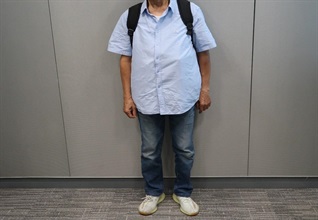 An incoming male passenger was sentenced to three months' imprisonment with a fine of $1,000 by the Fanling Magistrates' Courts today (October 22) for possessing duty-not-paid cigarettes and failing to declare them to Customs officers, in contravention of the Dutiable Commodities Ordinance. Photo shows the male passenger with the duty-not-paid cigarettes covered by his shirt.