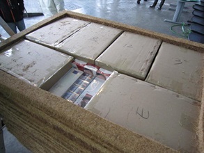 Suspected illicit cigarettes seized by Customs from pallets of corkwood boards.