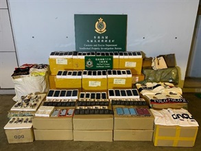 Hong Kong Customs seized a total of about 49 500 items of suspected counterfeit goods with an estimated market value of about $8.4 million in total at Man Kam To Control Point, Kwun Tong and Fanling on April 9 and yesterday (April 14). Photo shows some of the suspected counterfeit goods seized at Man Kam To Control Point, including mobile phones and accessories, watches and clothing.