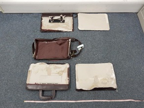 Suspected cocaine concealed inside the false compartment of the briefcase.