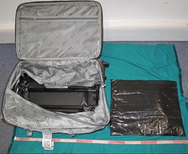 Methamphetamine concealed in the false compartment of the suitcase.